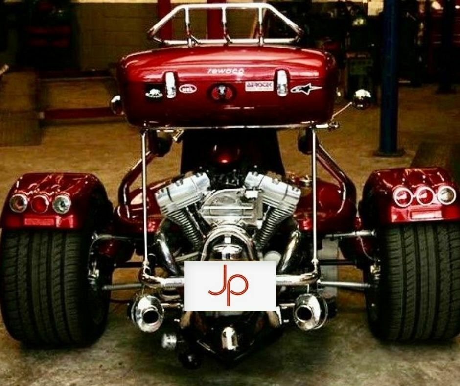 Image of a huge three wheeled motorbike with chrome engine highly polished and on show.