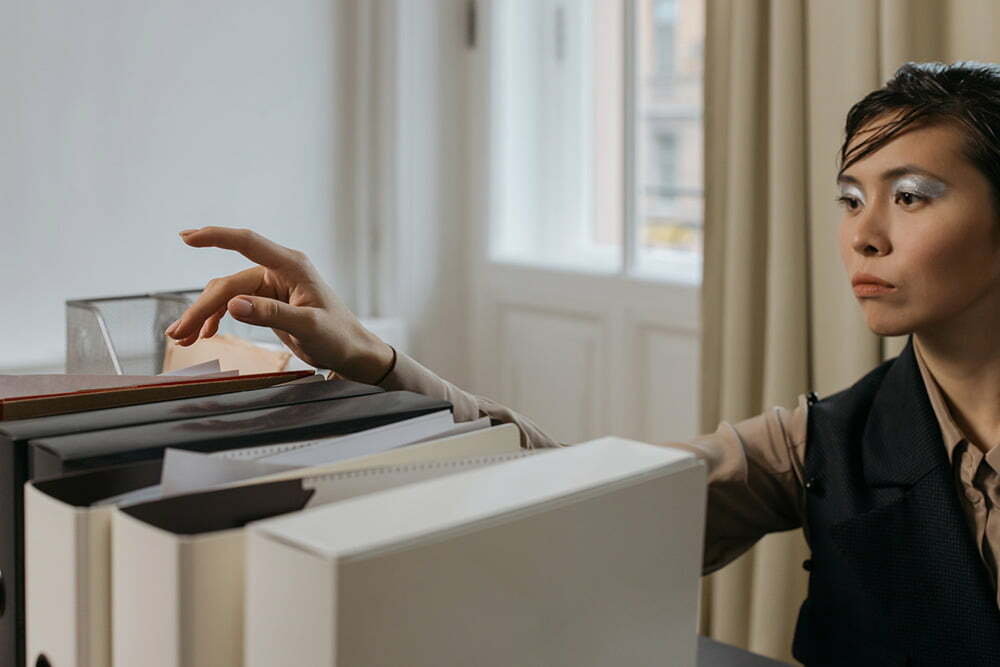 Woman organizing legal documents and contracts for due diligence